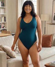 Photorealistic teal swimsuit try-on on the same person
